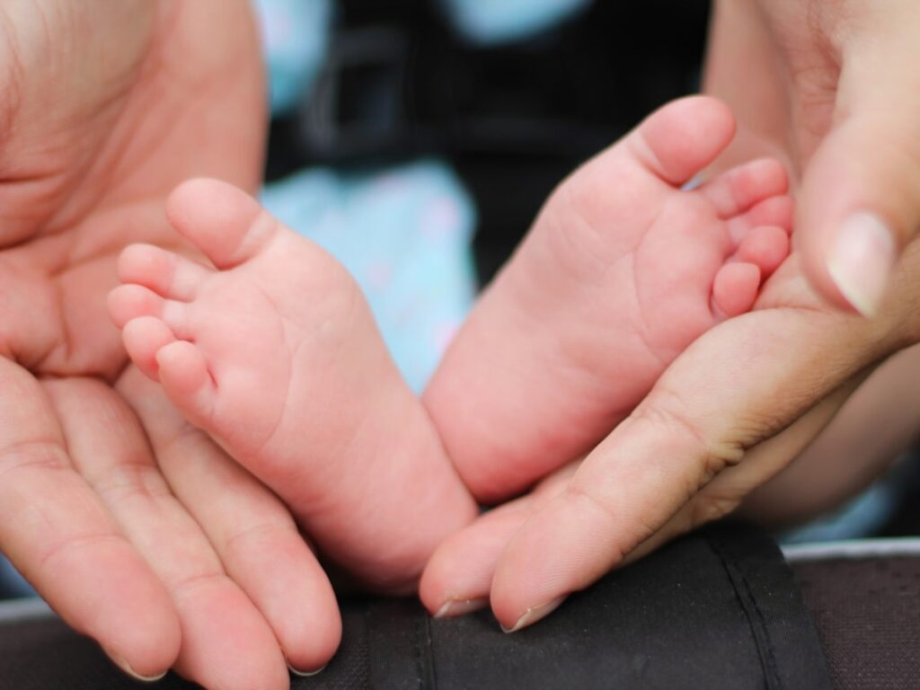 person-holding-baby-feet-f7bksvogwu Baby’s feet